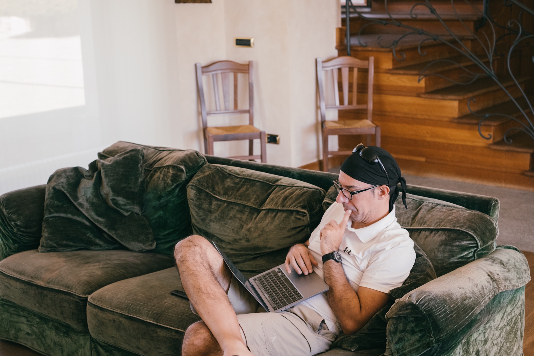 Person working on a laptop on the sofa