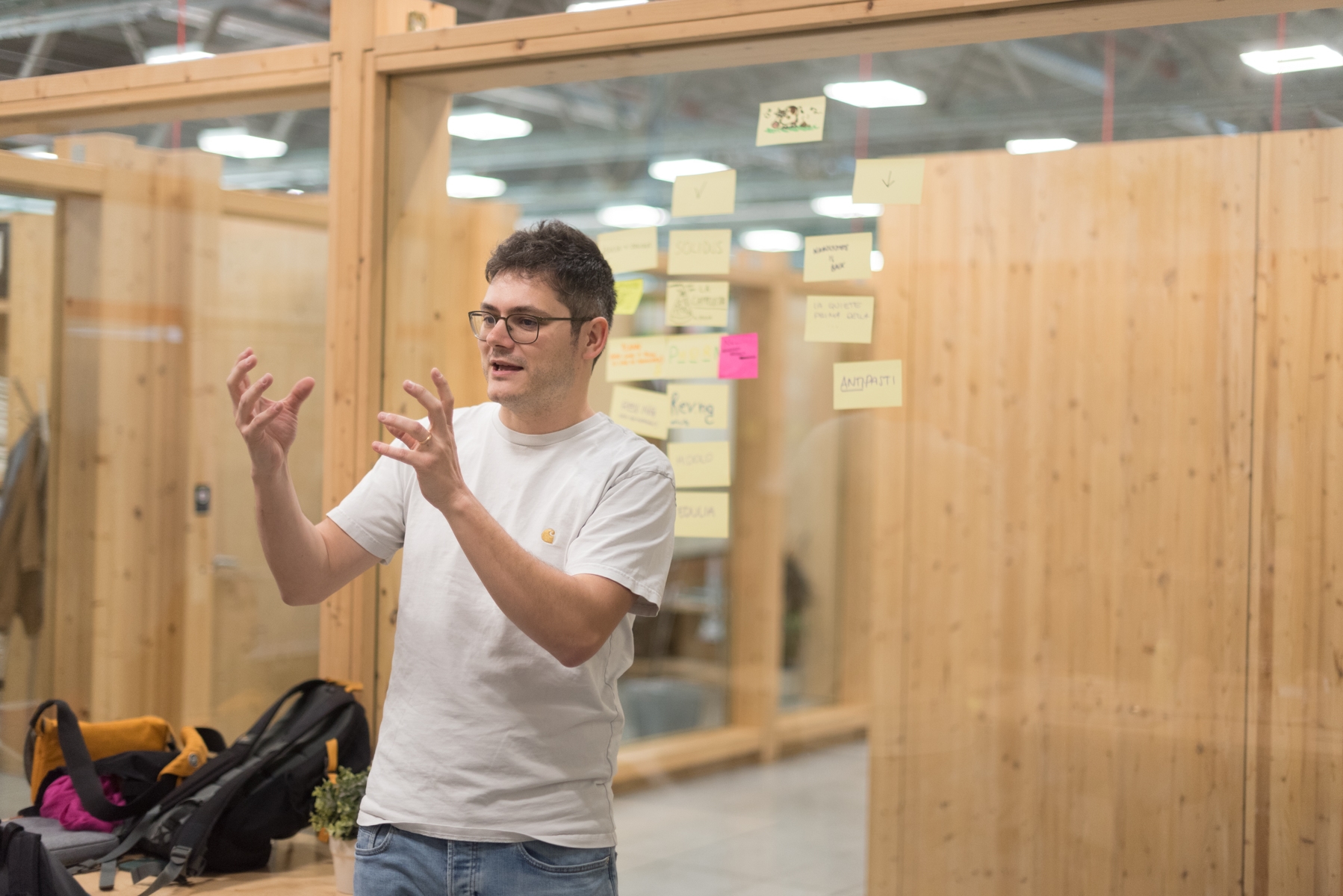 A Moze designer facilitating a workshop in front of a wall of sticky notes.